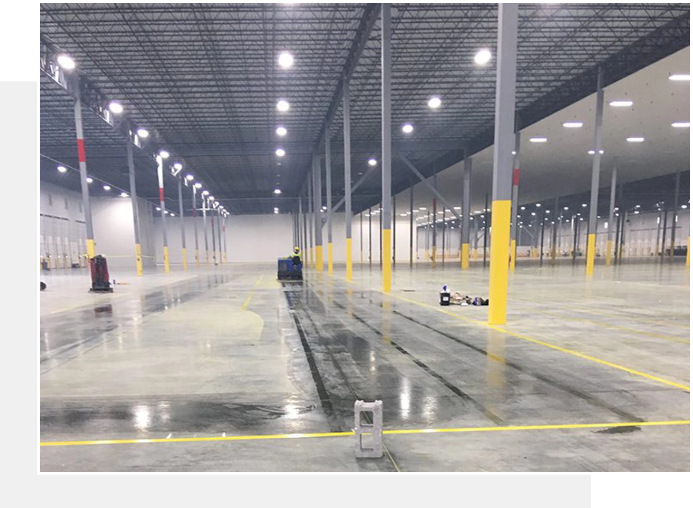 Clean warehouse floor with yellow lines.