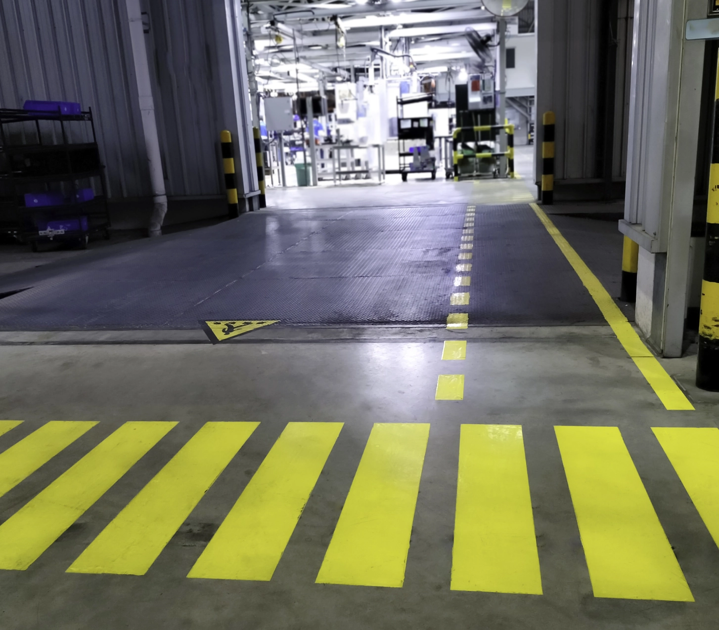 Factory floor with yellow pedestrian crossing.