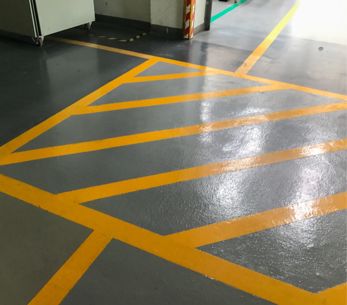 Grey floor with yellow warning stripes.