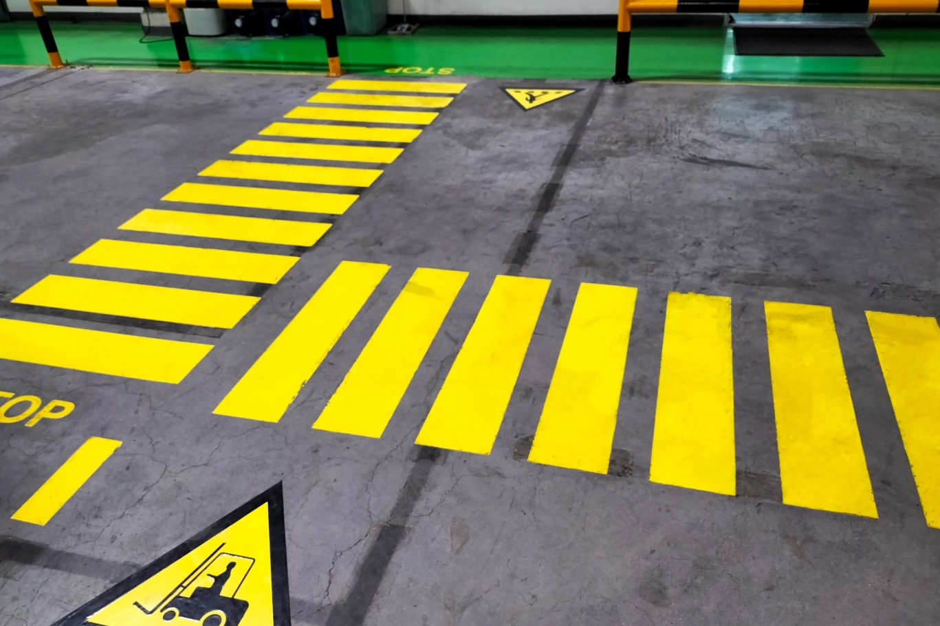 Yellow pedestrian crossing with forklift warning.