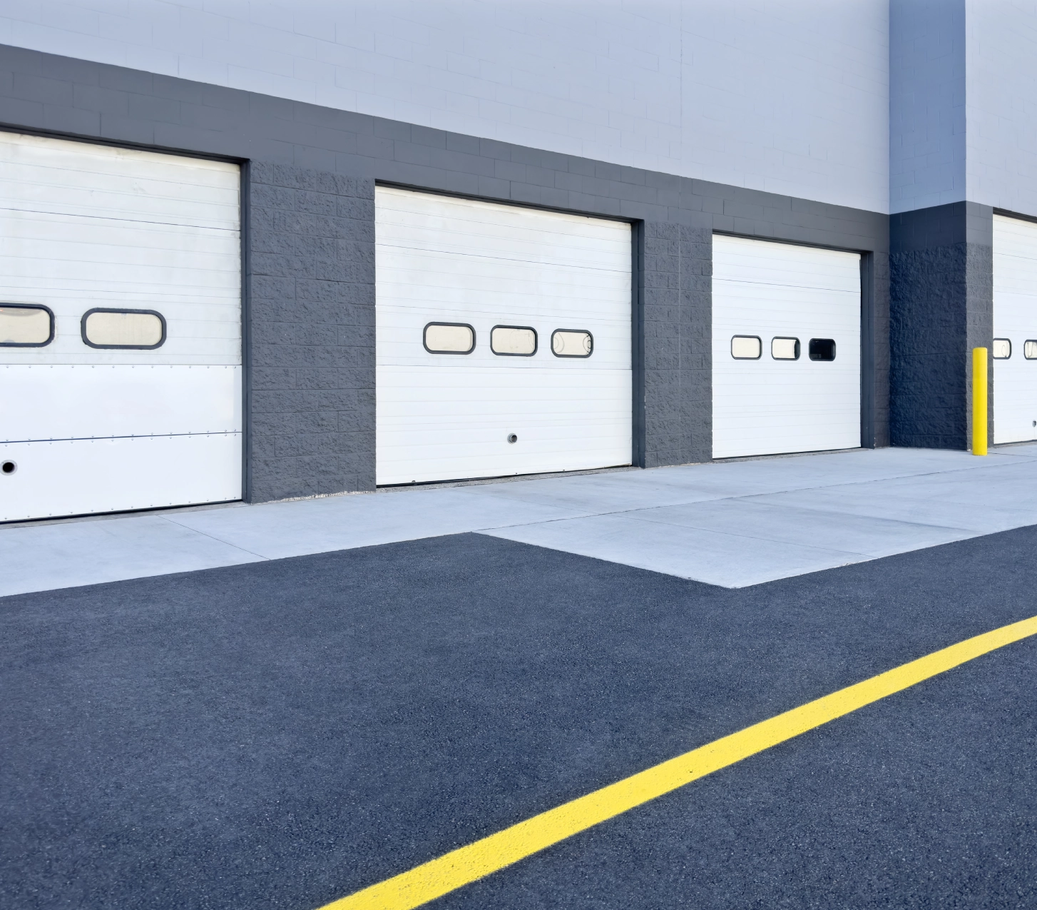 White loading dock doors and asphalt.