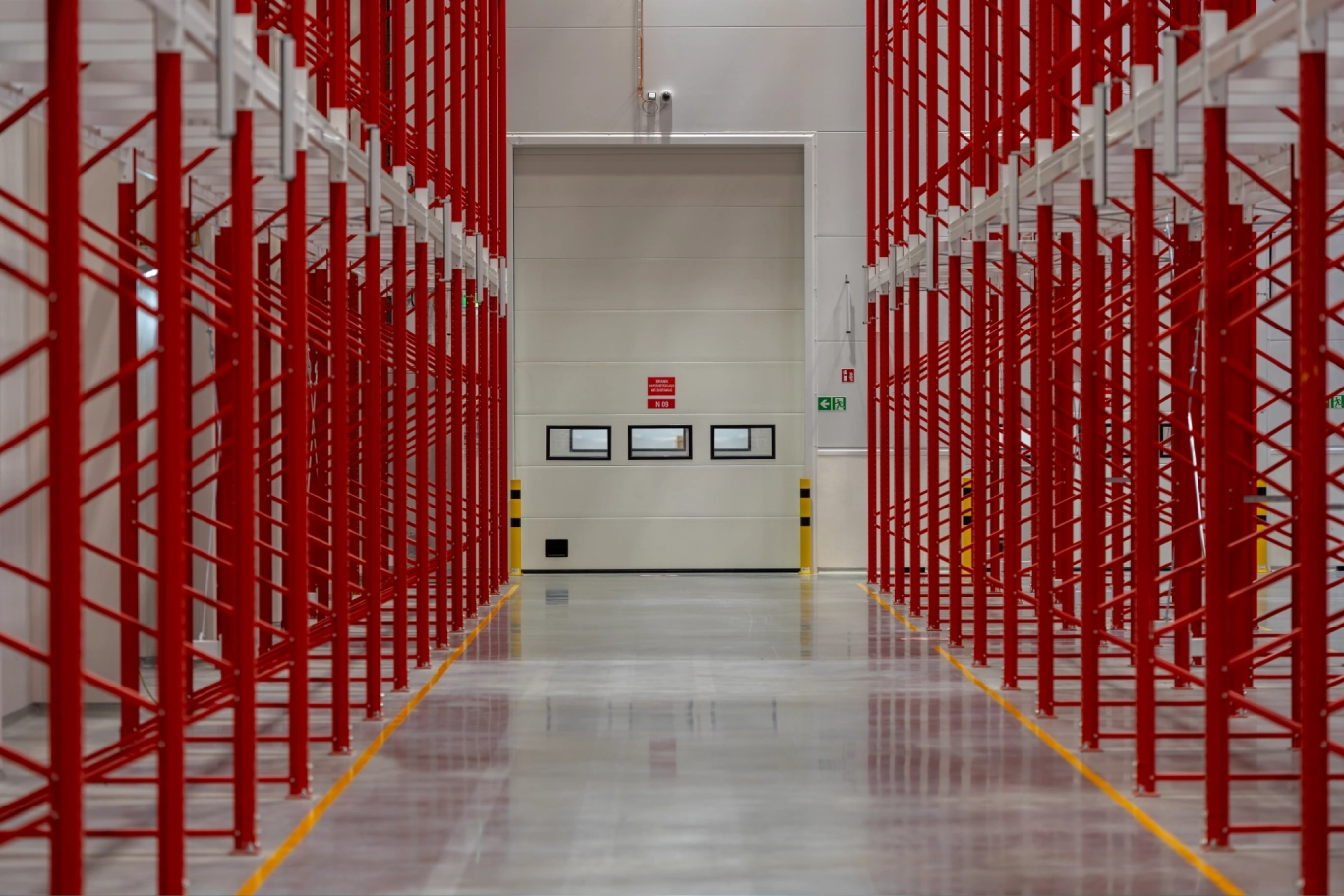 Red racking in a large warehouse.