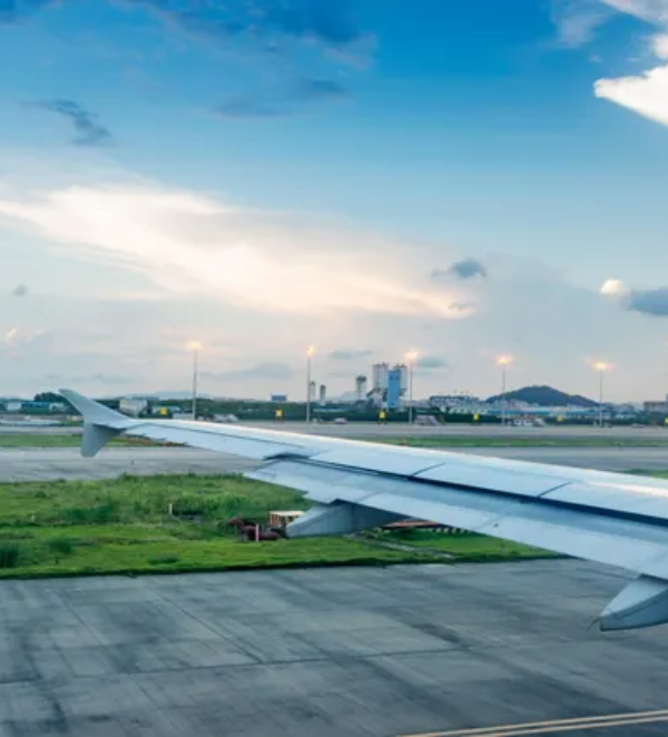 Airplane wing on airport tarmac.