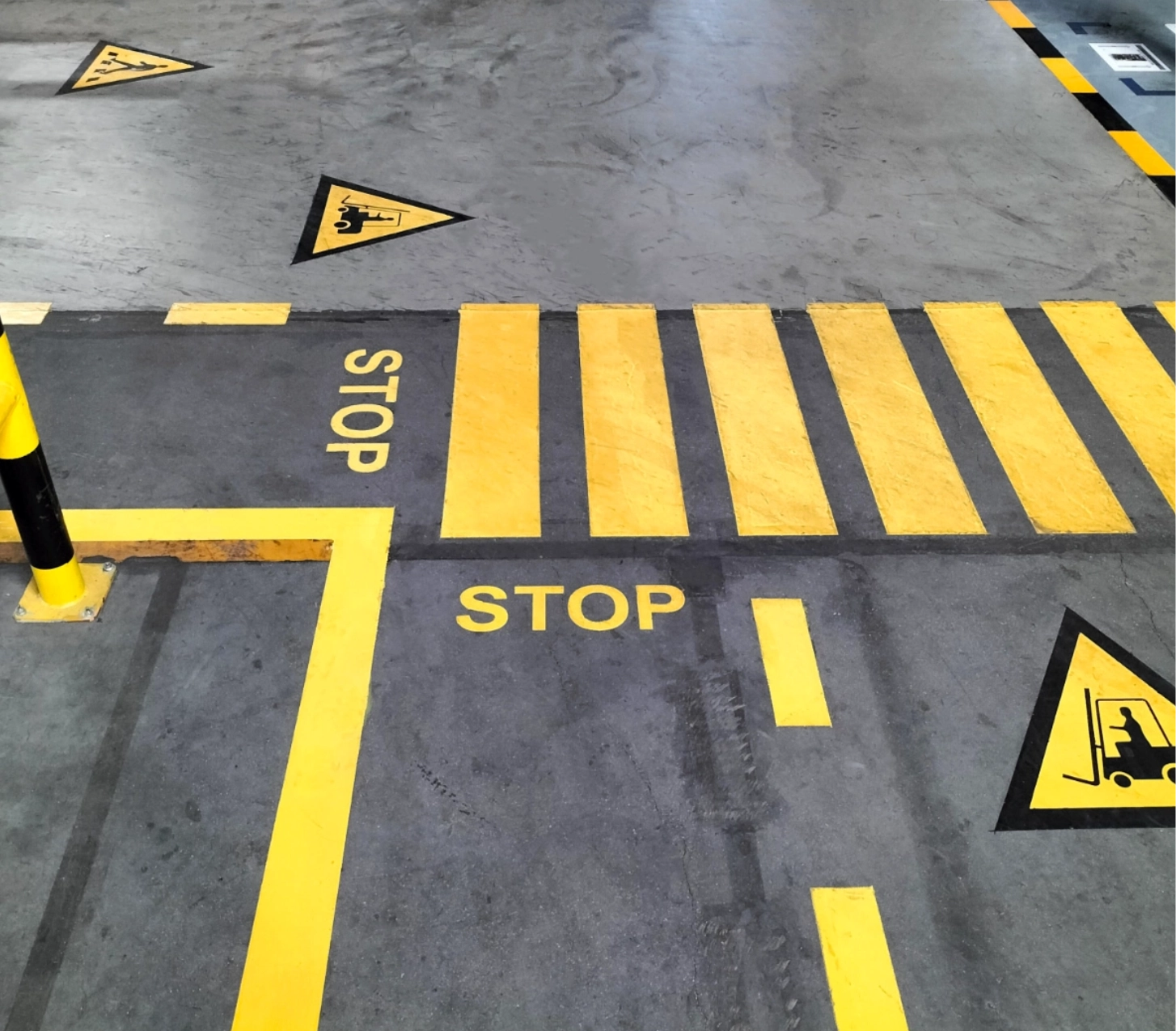 Floor markings: stop, pedestrian, forklift safety.