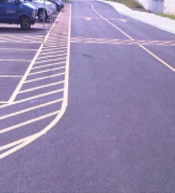 Parking lot with yellow lines and cars.