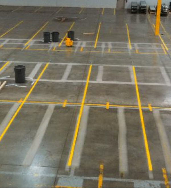 Warehouse floor with fresh yellow parking lines.