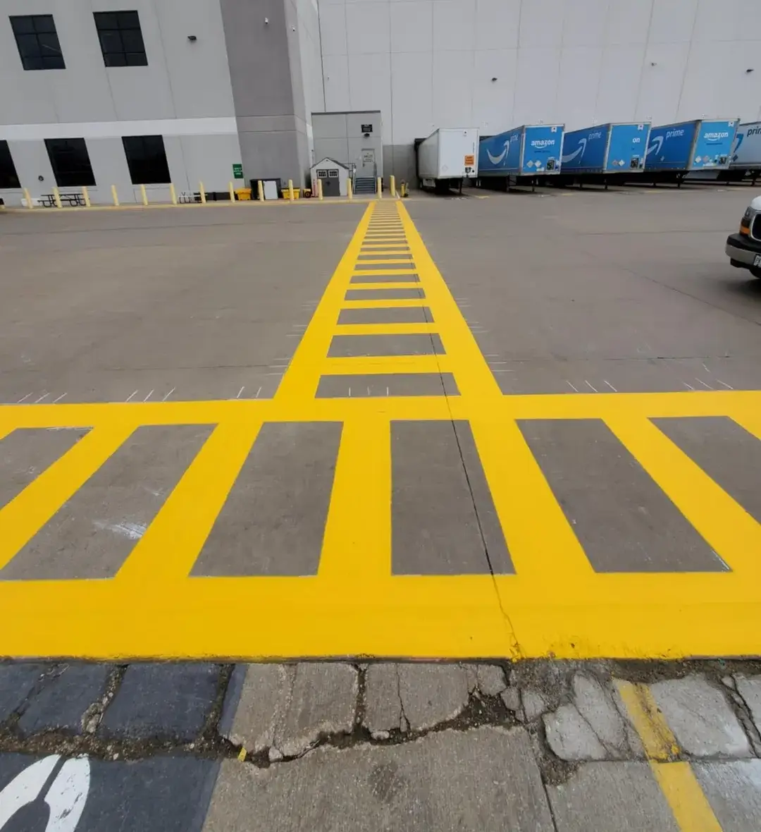 A yellow and black street with lines painted on it